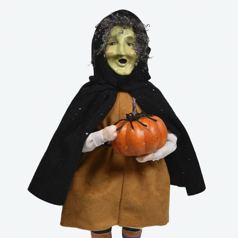 Halloween-themed figurine with a black hood, brown dress, and holding a pumpkin on a white background