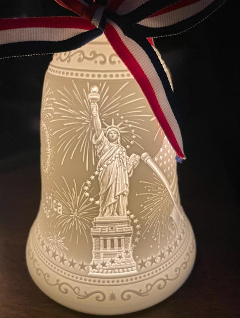 Decorative item with Statue of Liberty design and ribbon on a dark background