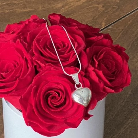 Sterling Silver "Jingle Heart" Necklace on roses